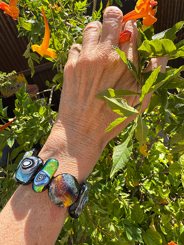 Dichroic sliders on a leather band