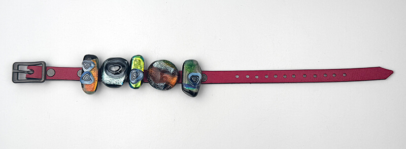Dichroic sliders on a leather band